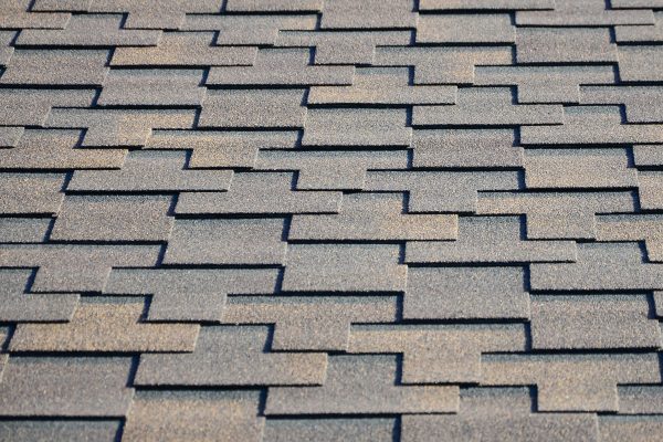 Modern roofing and decoration of chimneys. Flexible bitumen or slate shingles in rectangular shape in perspective.